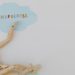 Wooden mannequin with mindfulness text on light blue cloud background, conveying calm.